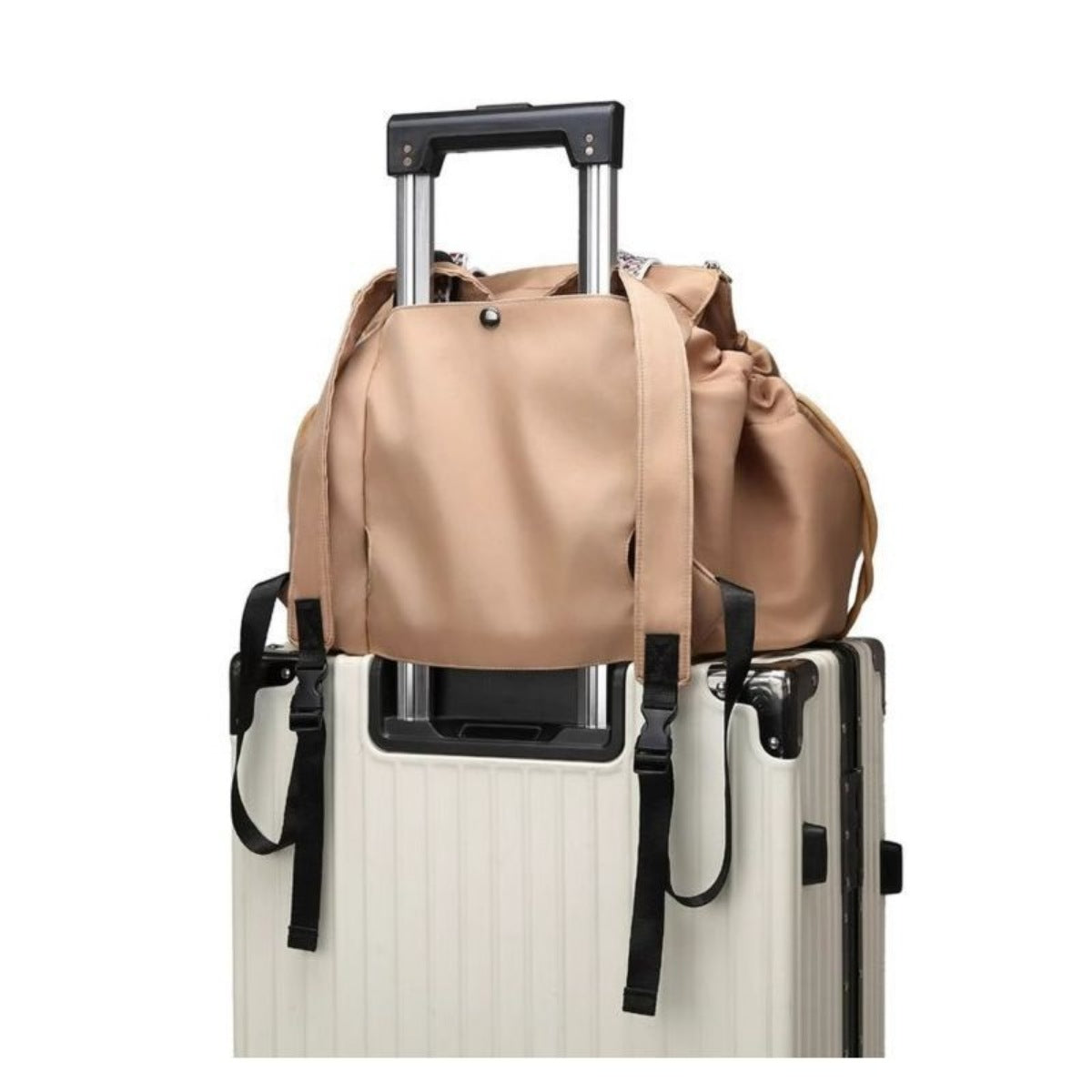 Beige duffel bag on top of a white suitcase with black handle and wheels.