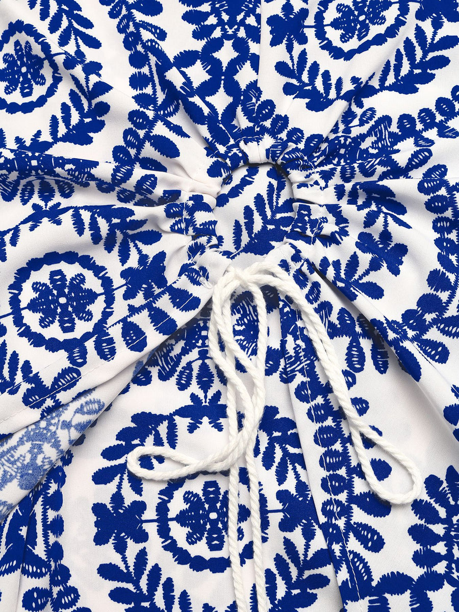 White fabric with blue floral patterns and a white drawstring.