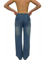 Blue jeans worn by a person on a white background