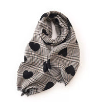 Plaid scarf with black heart patterns on a white background