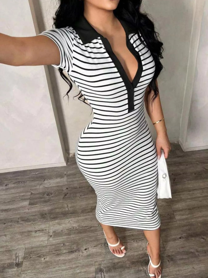 Woman wearing a black and white striped dress with a deep neckline.