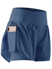Blue athletic shorts with a pocket holding a phone on a white background