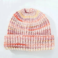Knitted beanie with multicolor pattern on a light gray background