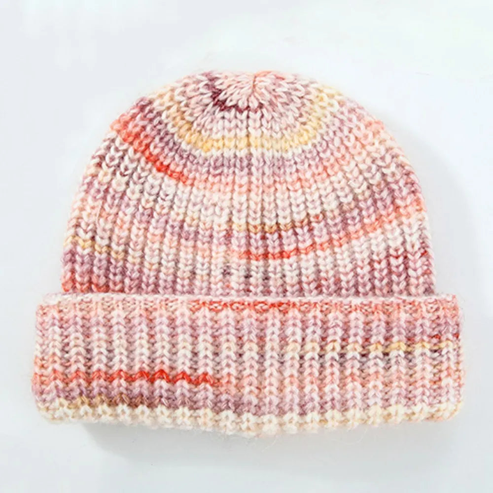 Knitted beanie with multicolor pattern on a light gray background