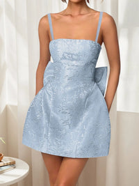 Light blue lace dress worn by a person with a neutral background