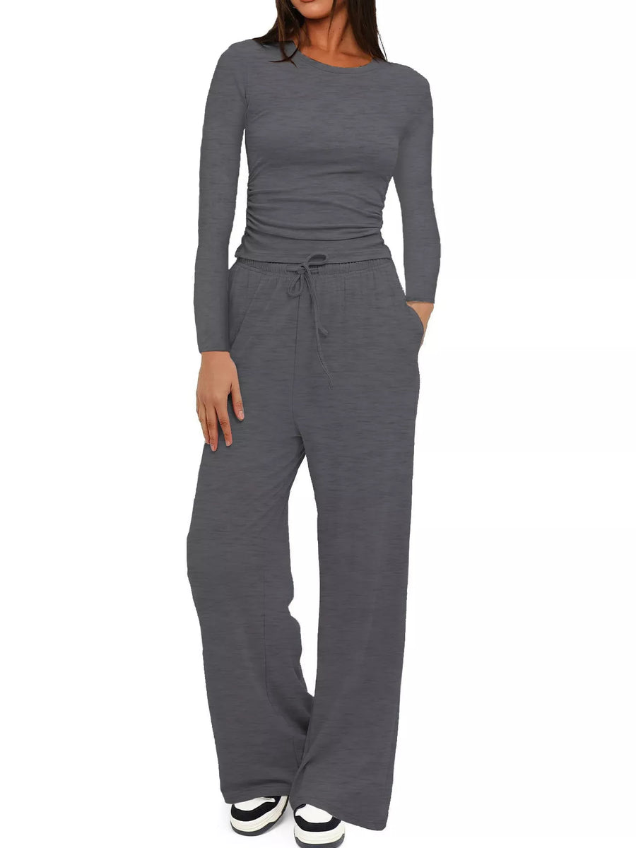 Gray jumpsuit with long sleeves and wide-leg pants on a white background