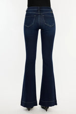 Dark blue flared jeans on a white background