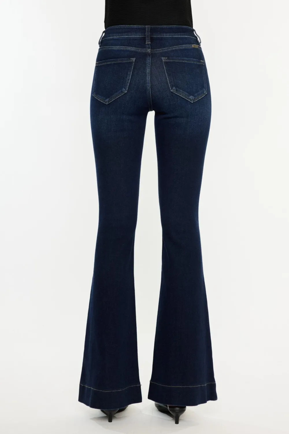 Dark blue flared jeans on a white background