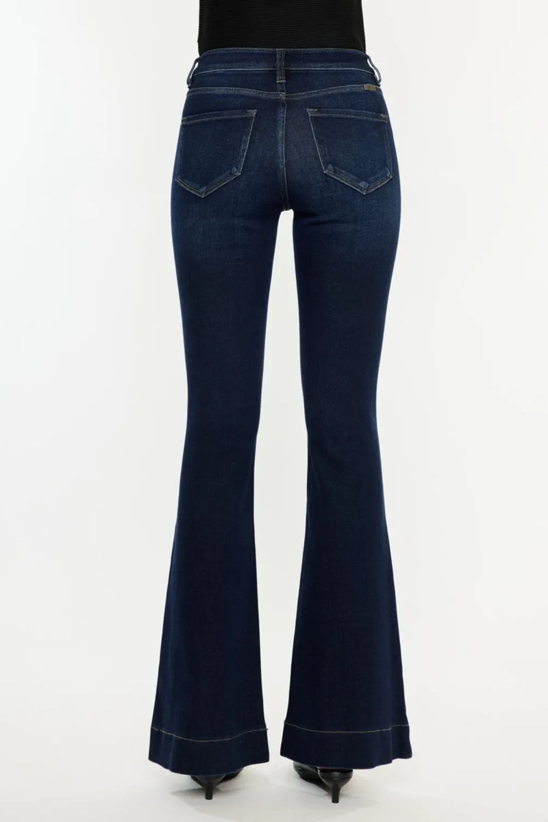 Dark blue flared jeans on a white background