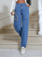 Person wearing blue jeans and white sneakers on a staircase.