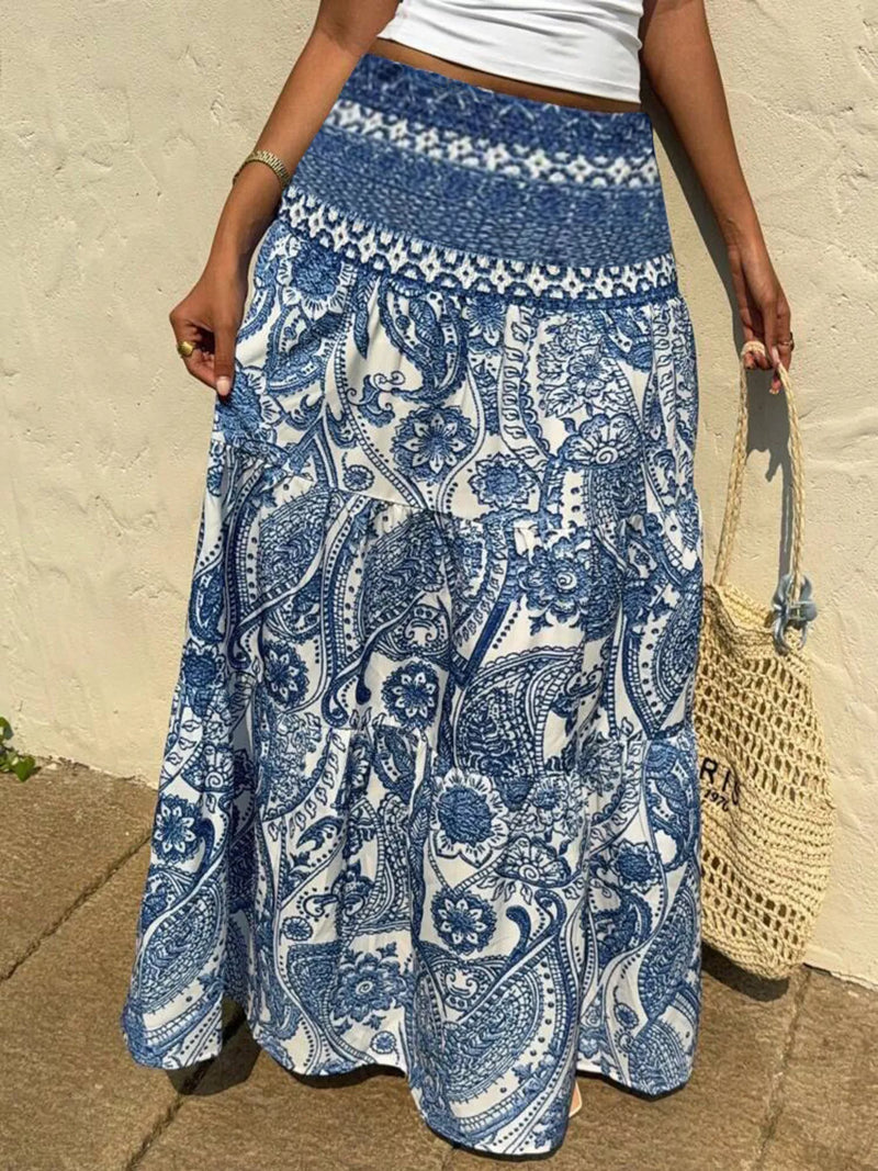 Person wearing a blue and white patterned skirt with a beige background