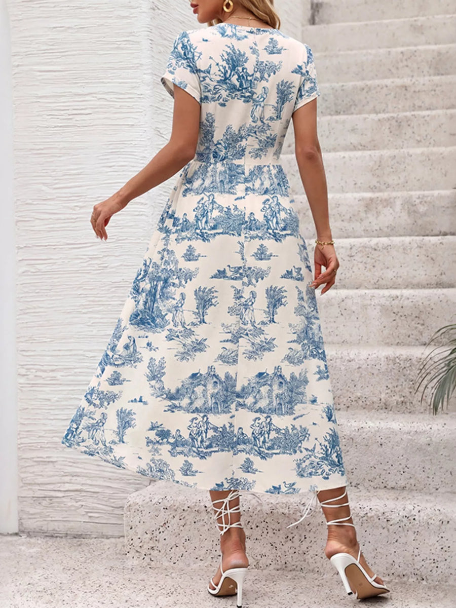 Woman wearing a blue and white patterned dress on stone steps.