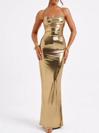 Gold metallic halter neck gown on a white background