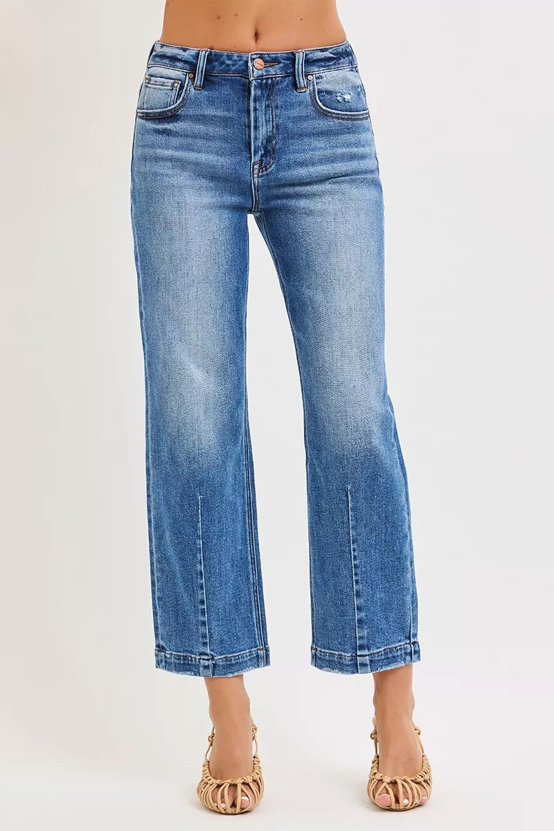 Blue jeans worn by a person on a white background