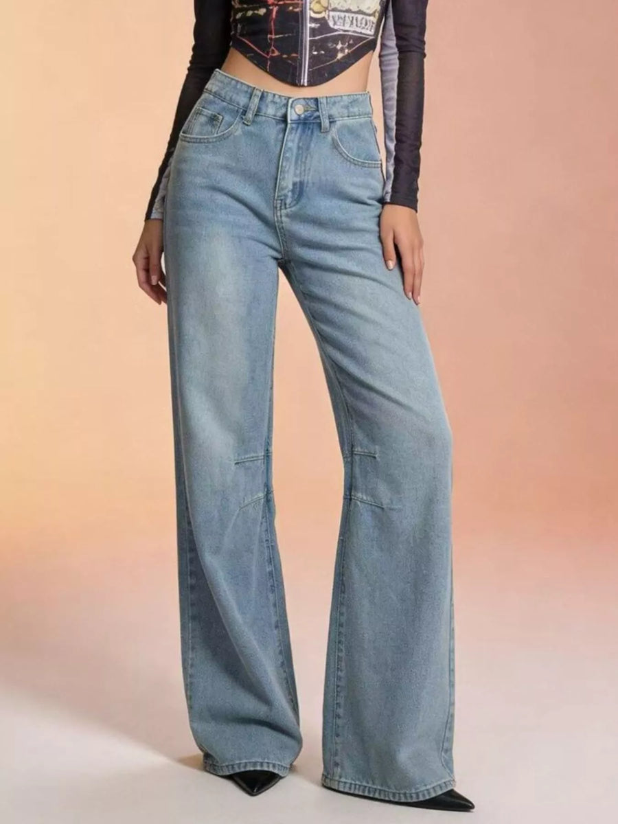 Light blue jeans worn by a person on a gradient background