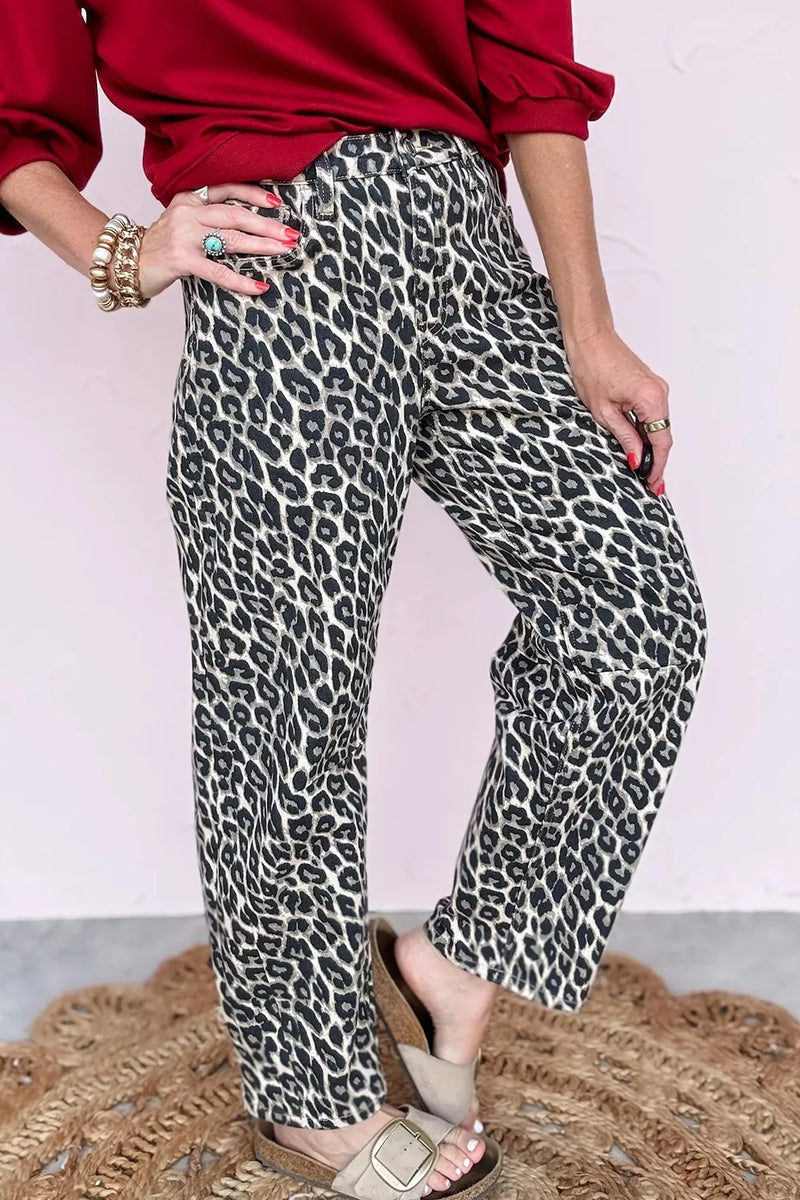 Person wearing red top and leopard print pants on a plain background