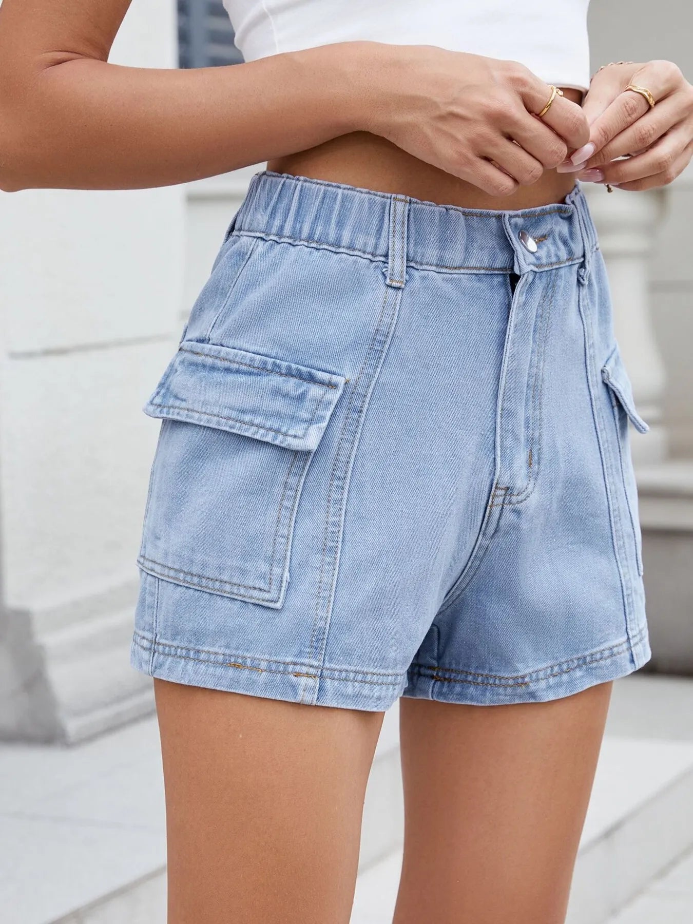 Denim shorts worn by a person with a blurred background