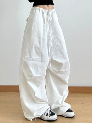 White wide-leg pants worn by a person on a plain background