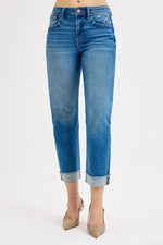 Blue jeans worn by a person on a white background