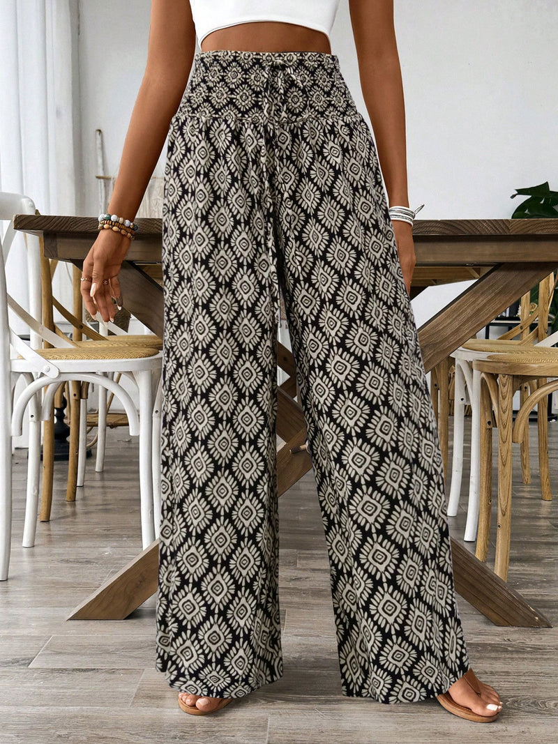 Person wearing patterned wide-leg pants in a casual setting.