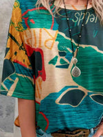 Person wearing a colorful dress with abstract patterns and a necklace.