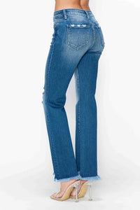 Blue jeans worn by a person on a white background