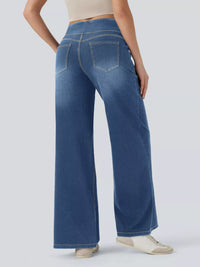 Person wearing blue wide-leg jeans on a white background