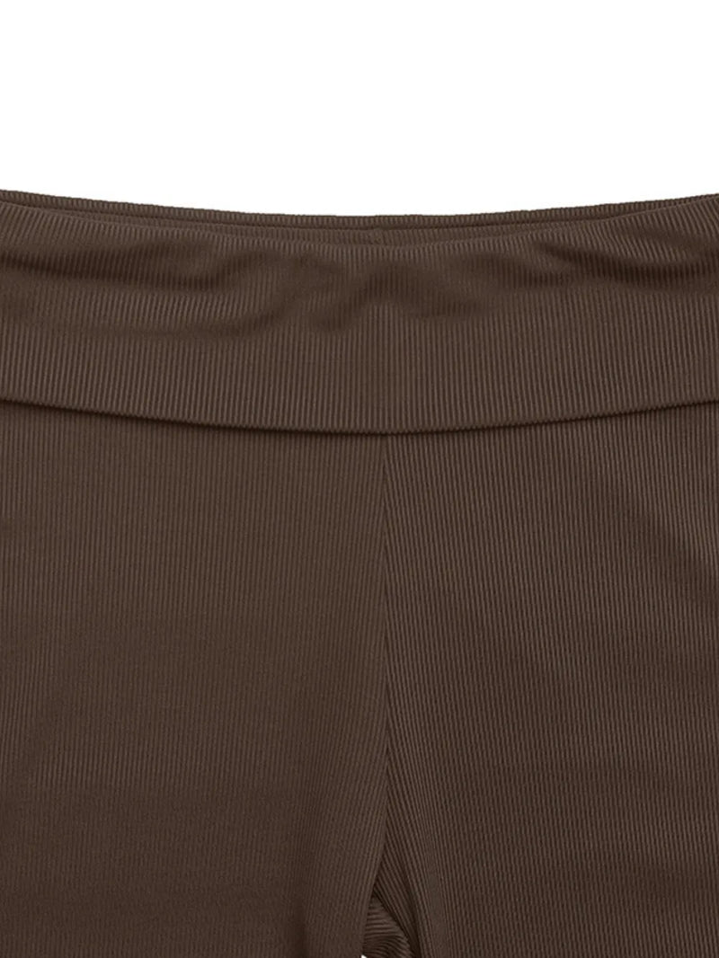 Close-up of a brown garment with a ribbed texture on a white background