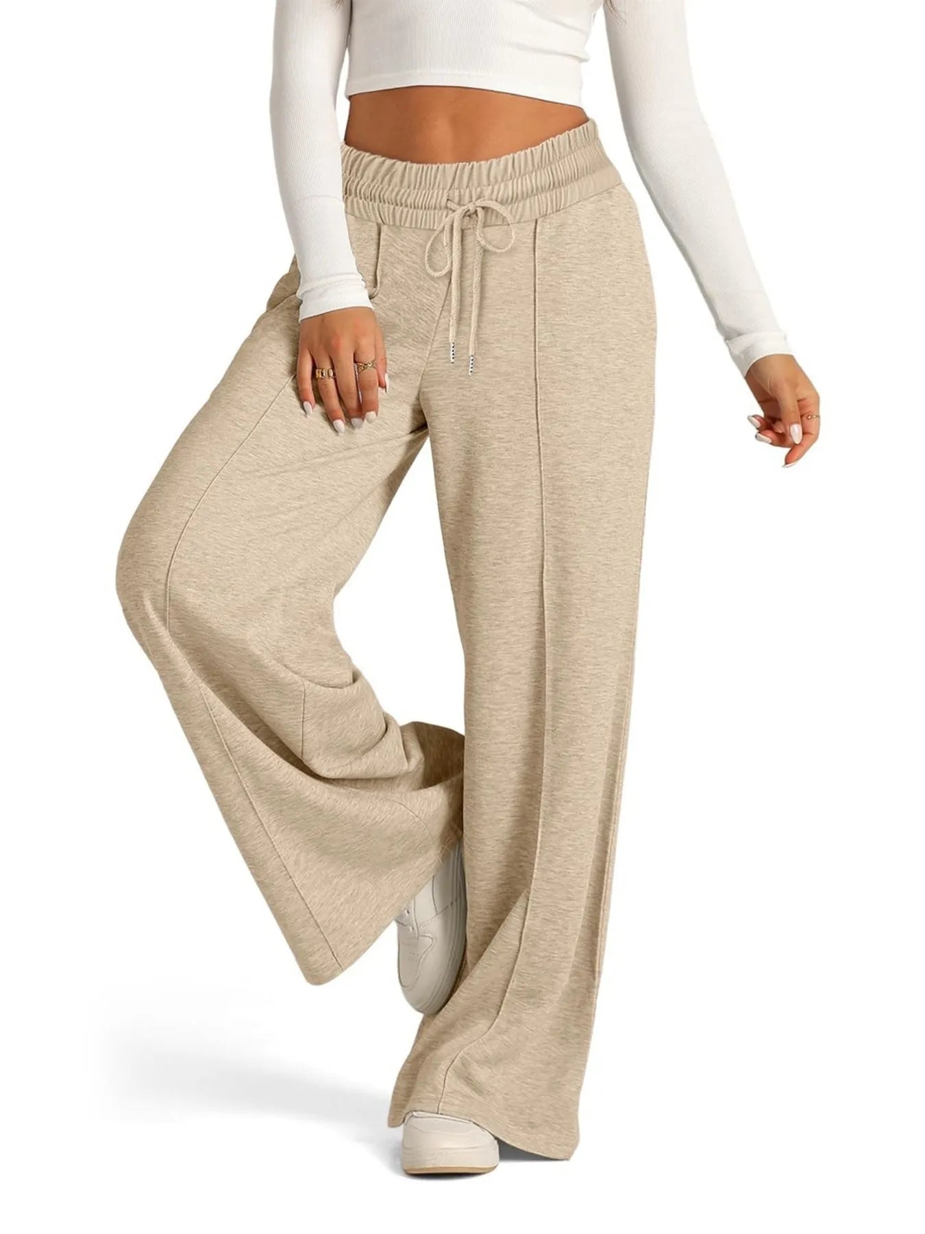 Beige wide-leg pants worn by a person on a white background