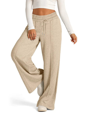 Beige wide-leg pants worn by a person on a white background
