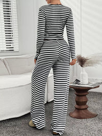 Person wearing a black and white striped jumpsuit in a living room setting.