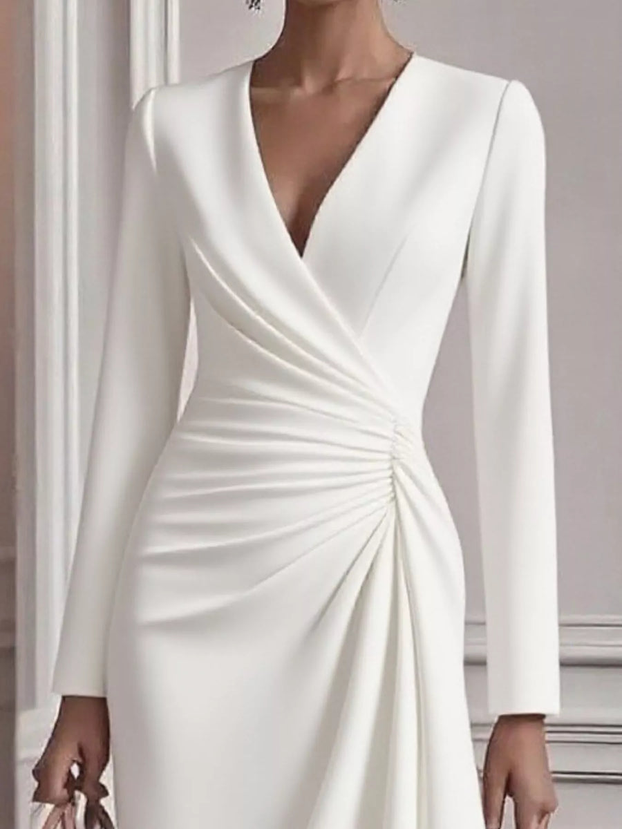 White long-sleeve dress with a V-neckline on a neutral background
