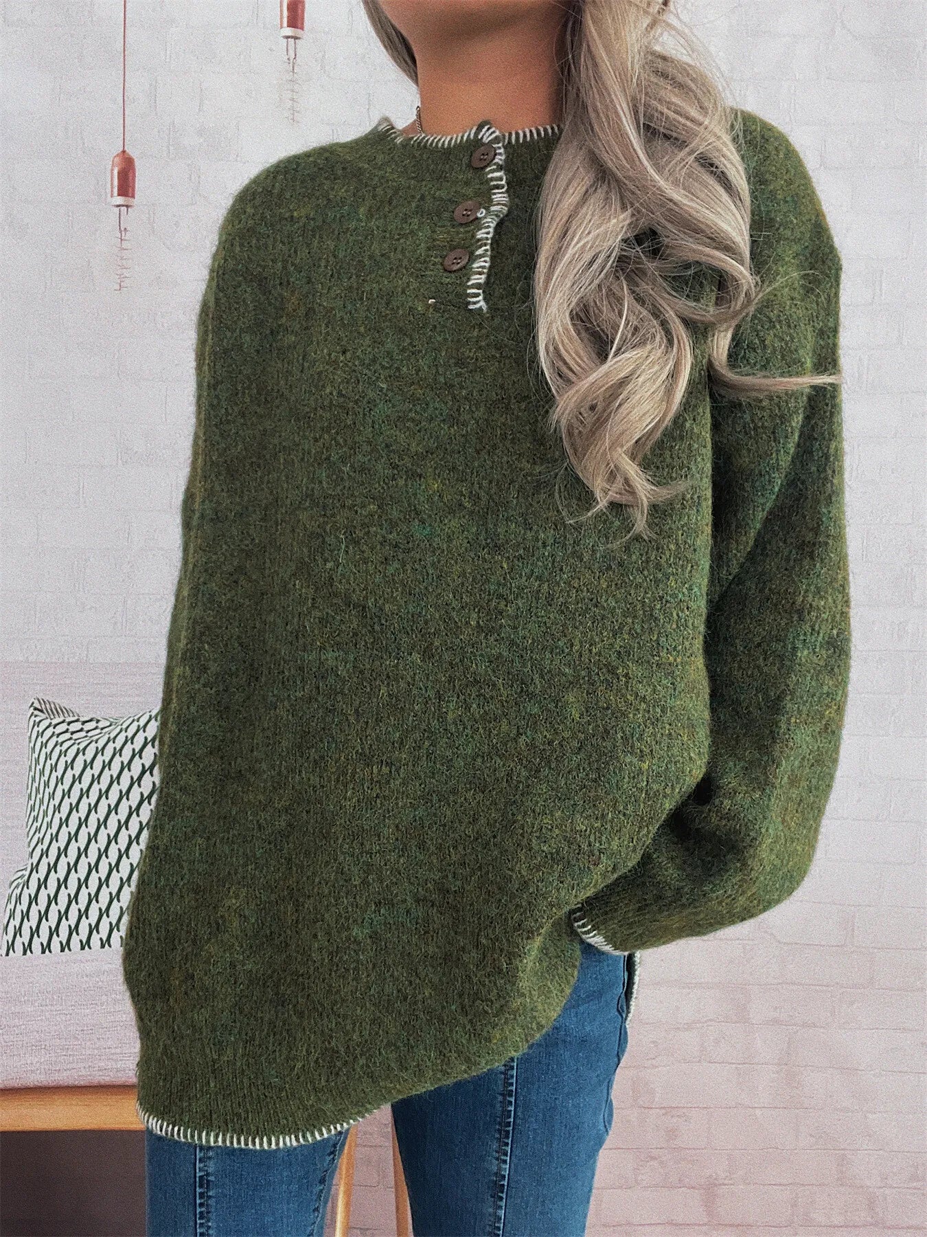 Person wearing a green sweater with a blurred background
