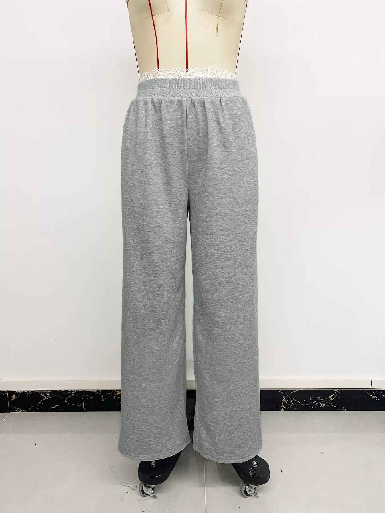 Gray sweatpants on a mannequin against a white background
