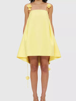 Yellow dress with floral straps on a white background