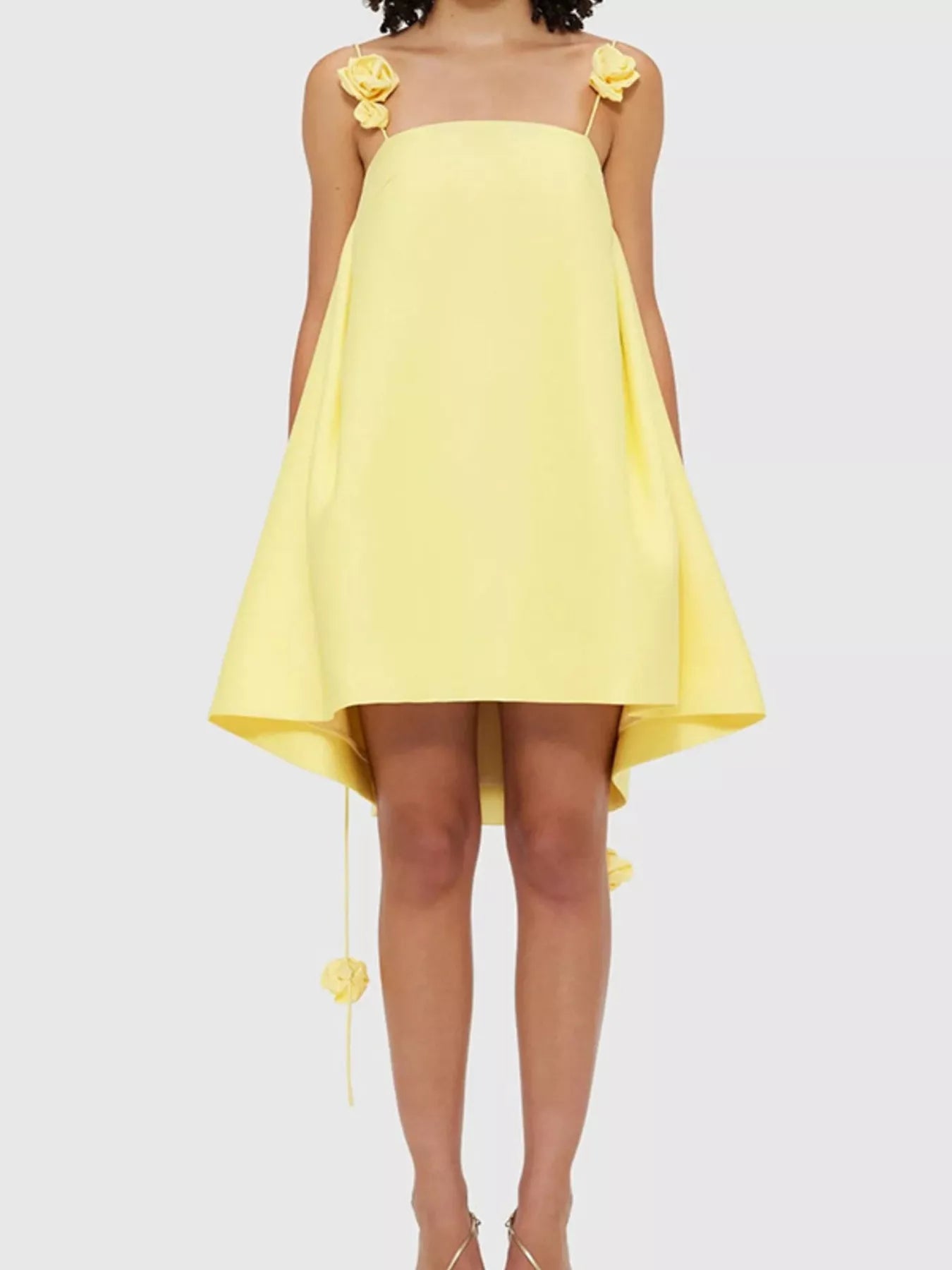 Yellow dress with floral straps on a white background