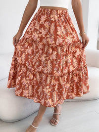 Person wearing a floral tiered skirt with a white background