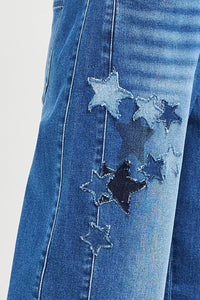 Blue denim jacket with star patches on a light gray background