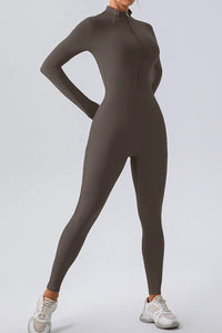 Person wearing a brown full-body suit on a light gray background