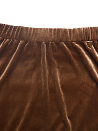 Close-up of brown velvet fabric with a white background