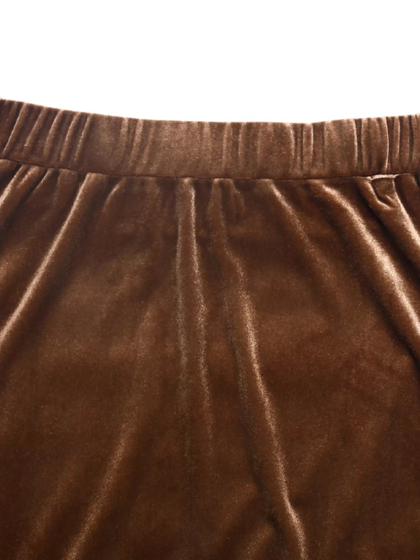 Close-up of brown velvet fabric with a white background