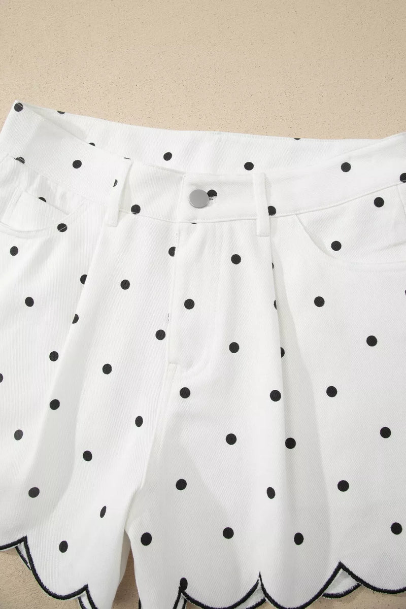 White shorts with black polka dots on a beige background