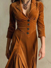 Brown velvet dress with buttons on a neutral background