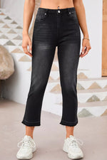 Person wearing black jeans and white sneakers in a casual setting