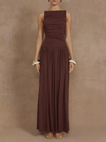 Woman wearing a brown dress against a beige background