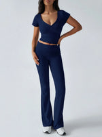 Woman wearing a navy blue outfit on a white background