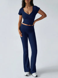 Woman wearing a navy blue outfit on a white background