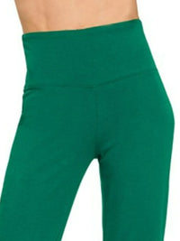 Green leggings worn by a person on a white background
