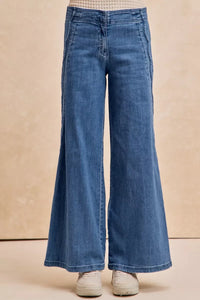 Blue wide-leg jeans on a beige background