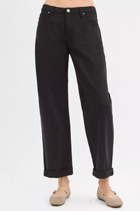 Black pants worn by a person on a white background